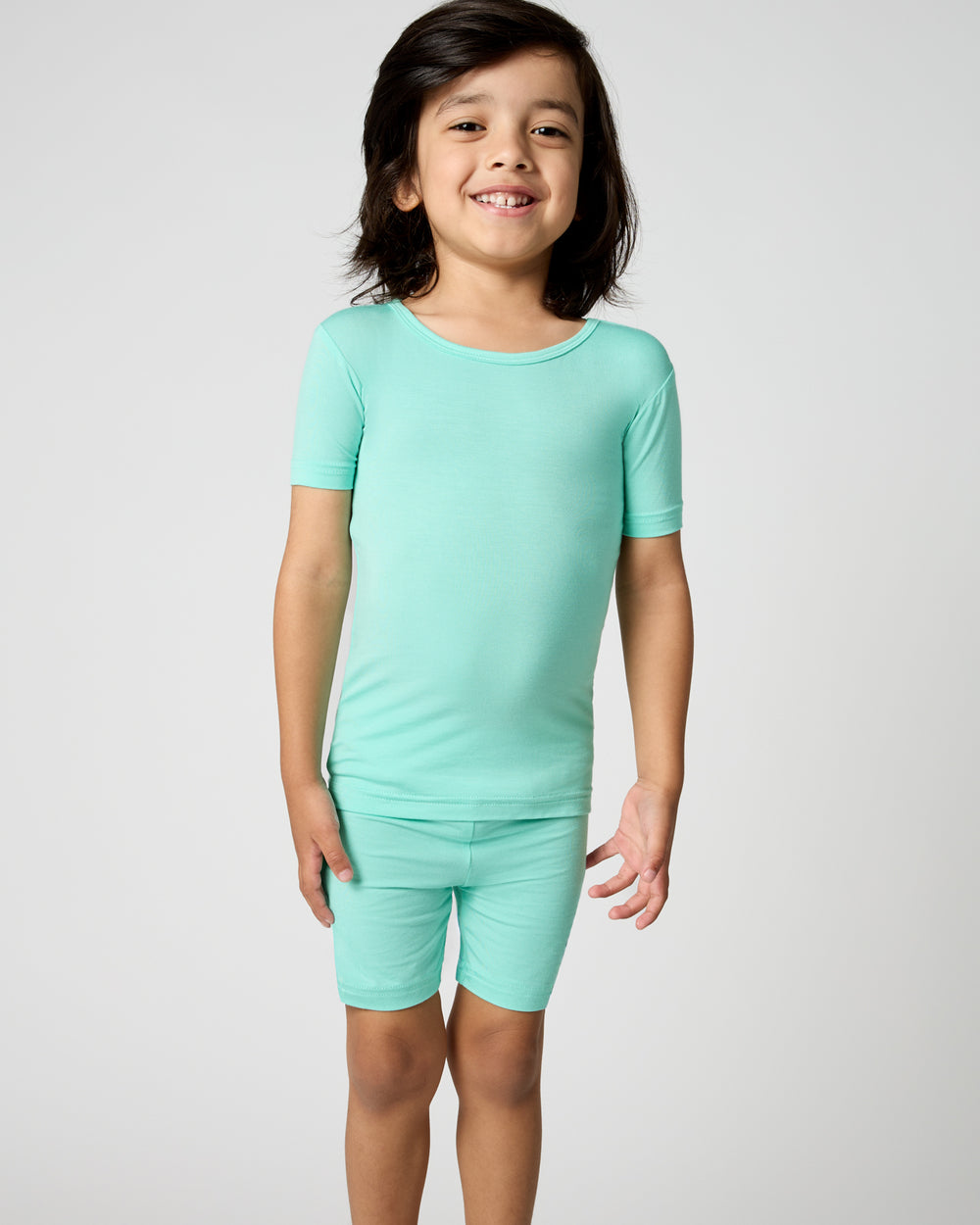Child wearing the Ocean Mist Two-Piece Short Sleeve & Shorts Pajama Set