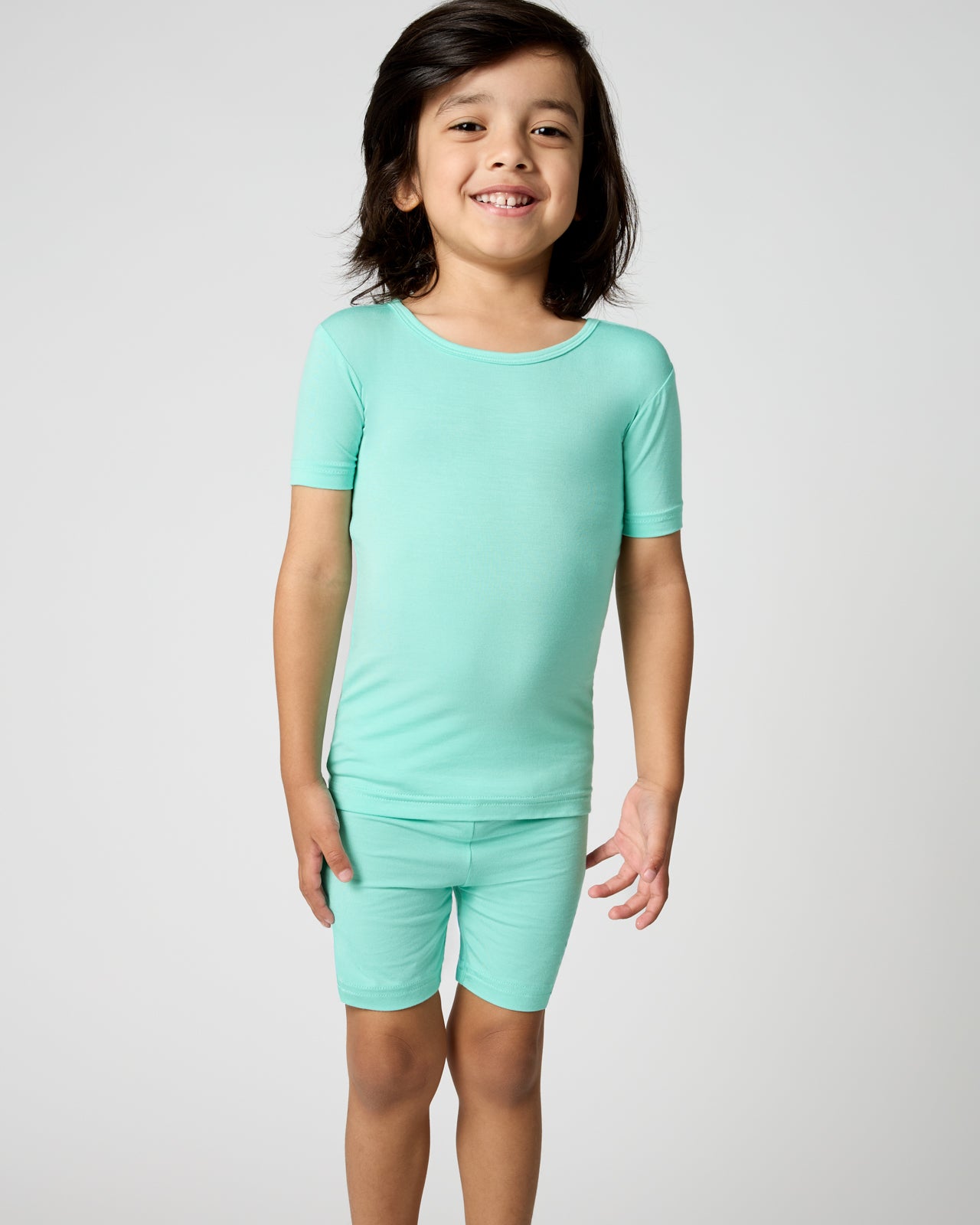 Child wearing the Ocean Mist Two-Piece Short Sleeve & Shorts Pajama Set