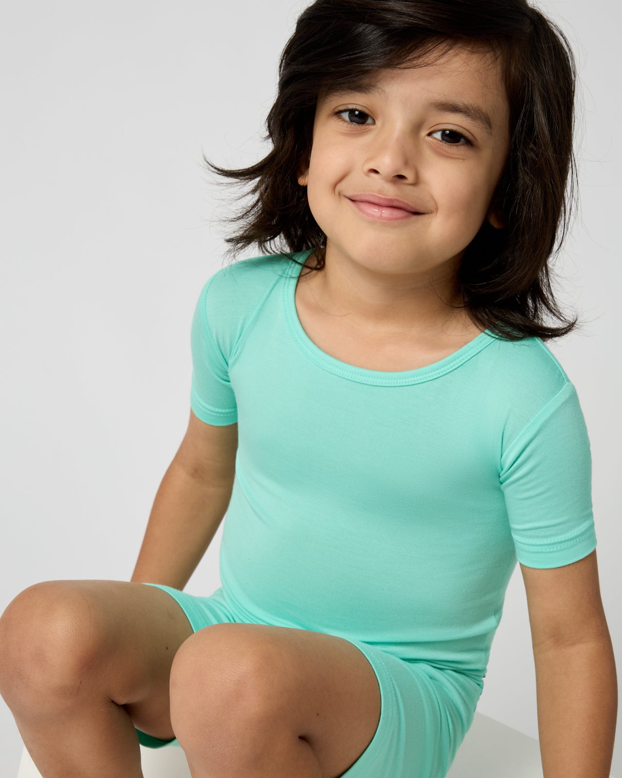 Close up of child wearing the Ocean Mist Two-Piece Short Sleeve & Shorts Pajama Set