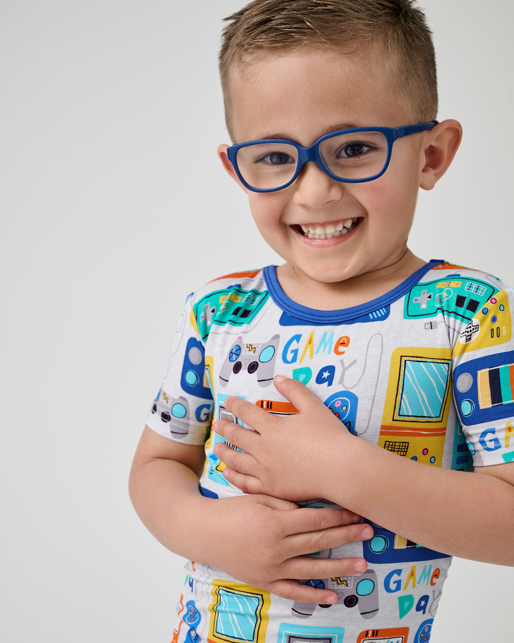Close up of boy wearing the Game On Two-Piece Short Sleeve & Shorts Pajama Set