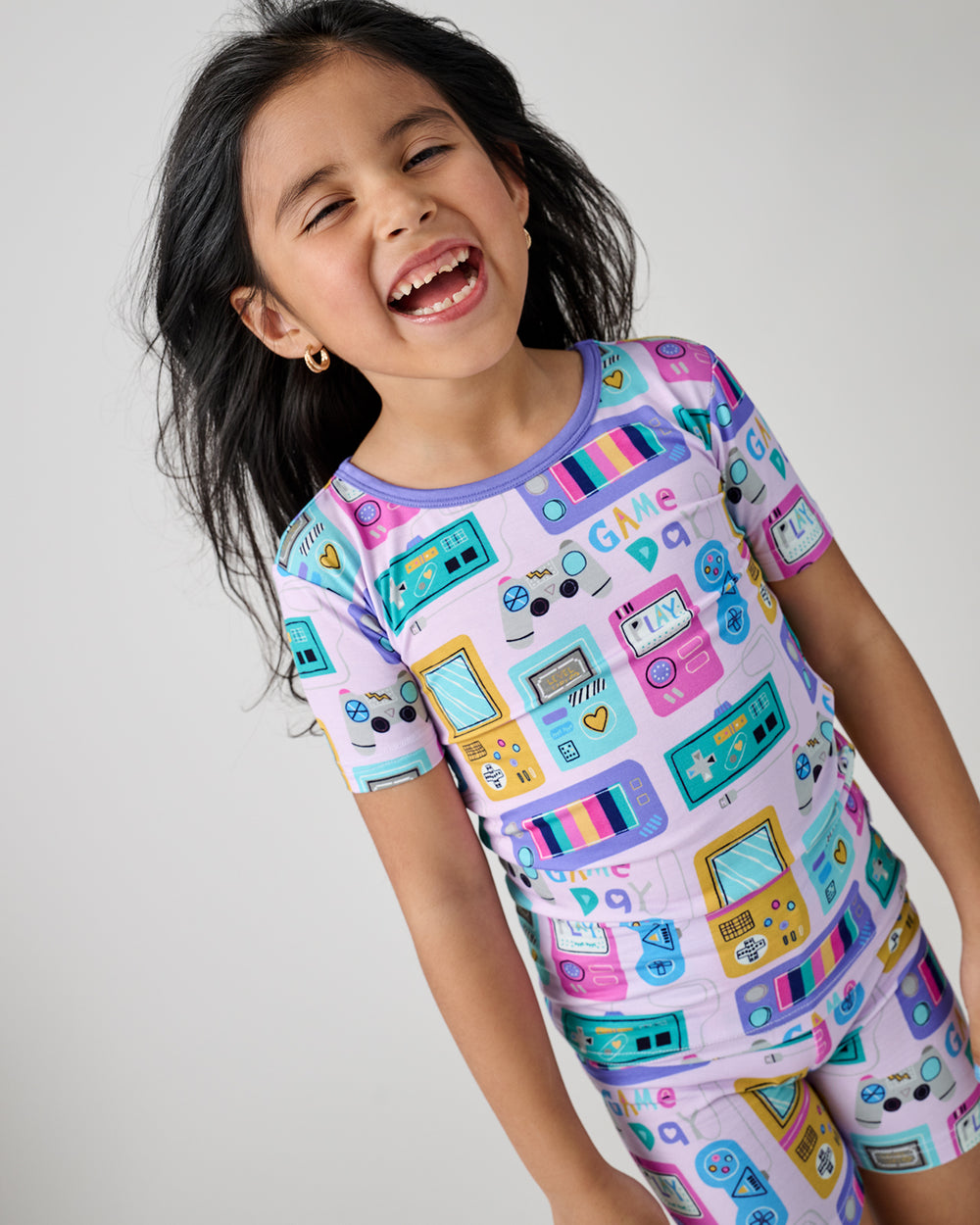Close up of girl wearing the Purple Game On Two-Piece Short Sleeve & Shorts Pajama Set