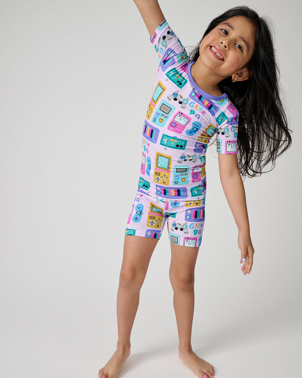 Standing girl wearing the Purple Game On Two-Piece Short Sleeve & Shorts Pajama Set