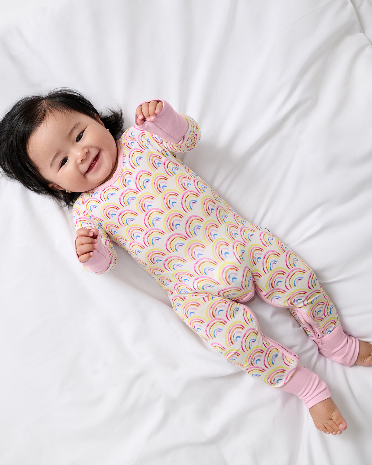 Aerial view of baby wearing the Pastel Rainbows Crescent Zippy