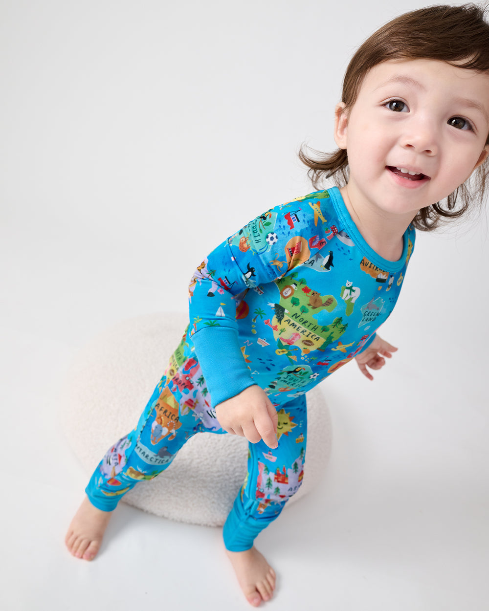 Walking toddler wearing the Around The World Crescent Zippy
