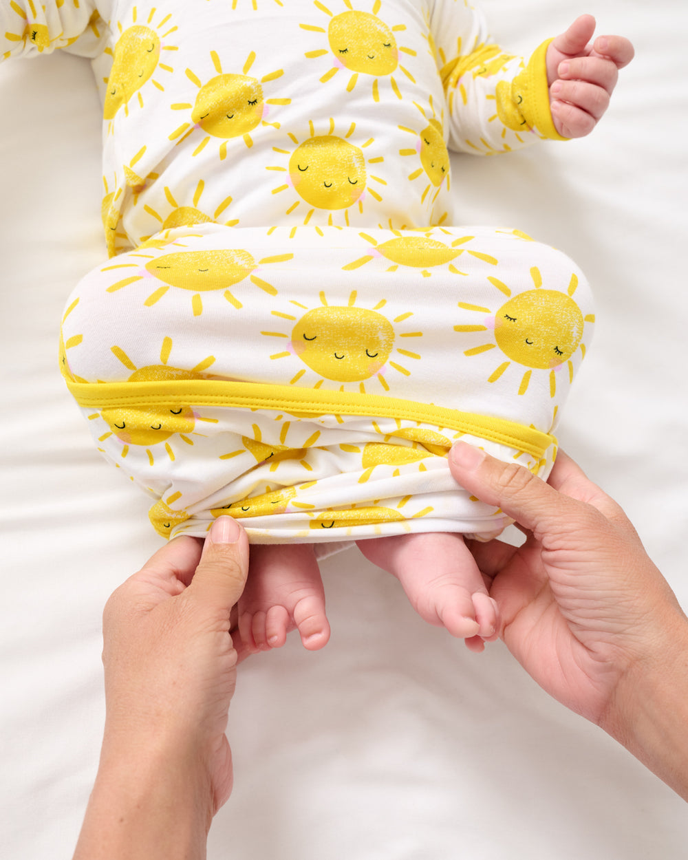 Adult demonstrating the envelope sweep on the Sunshine Infant Gown