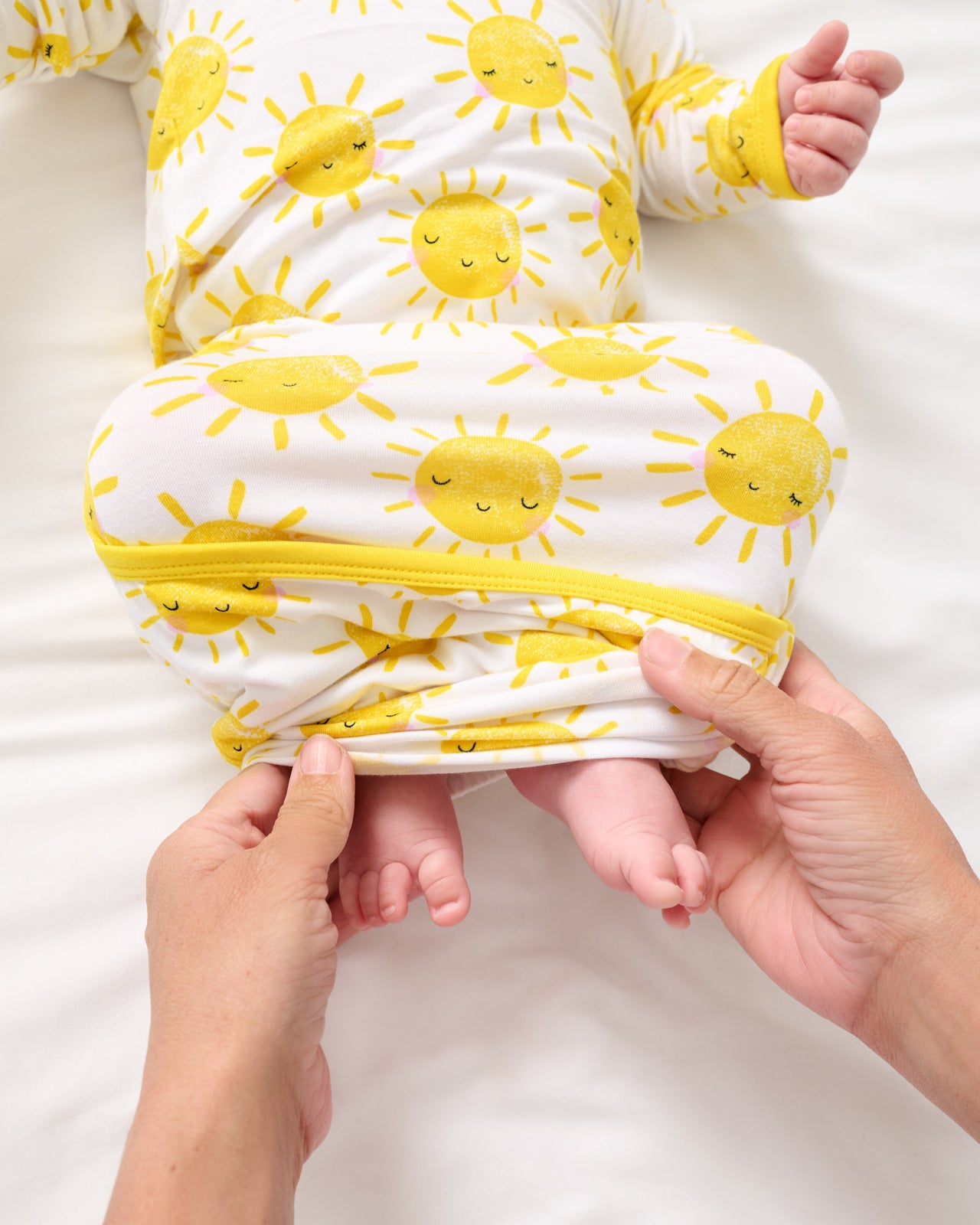 Adult demonstrating the envelope sweep on the Sunshine Infant Gown