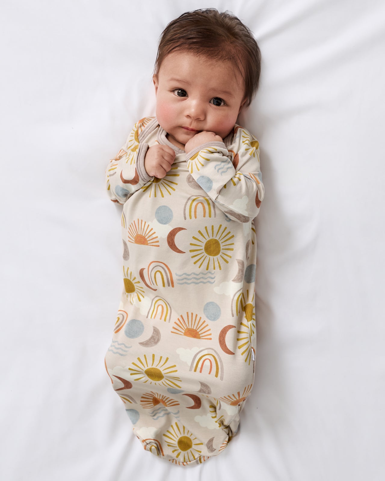 Aerial view of baby wearing the Desert Sunrise Infant Gown