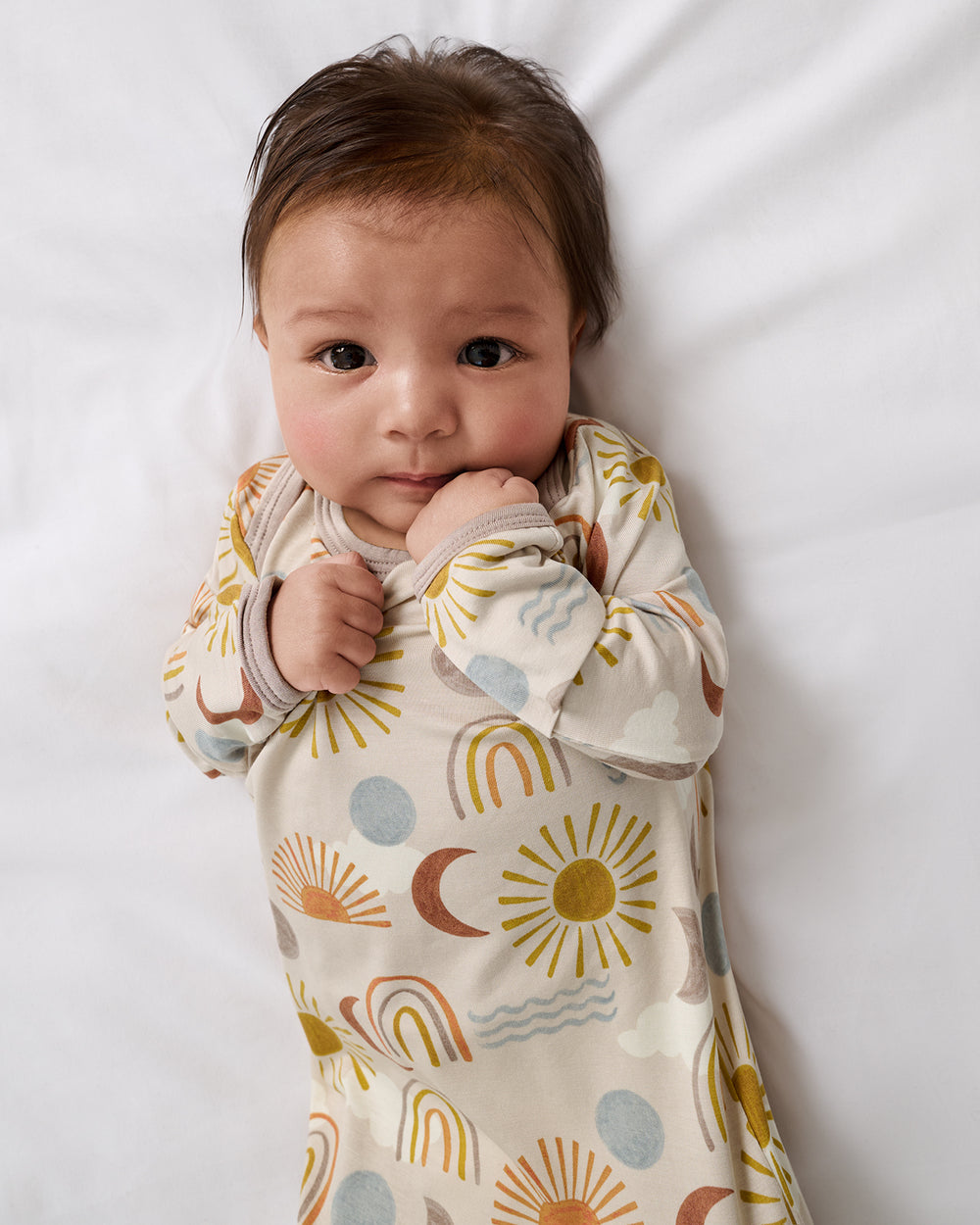 Close up of newborn wearing the Desert Sunrise Infant Gown