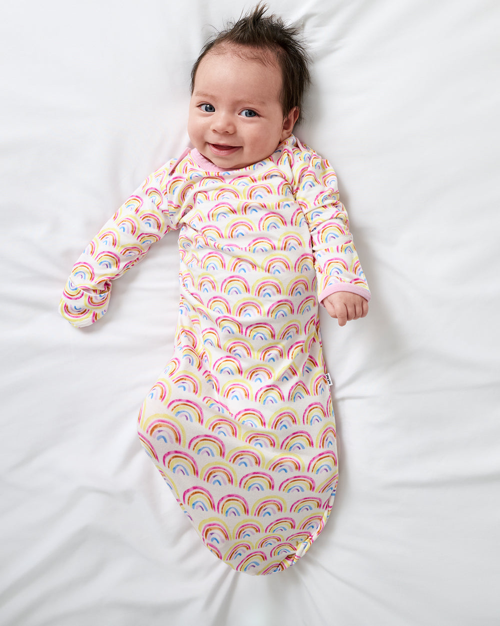 Aerial view of newborn wearing the Pastel Rainbows Infant Gown