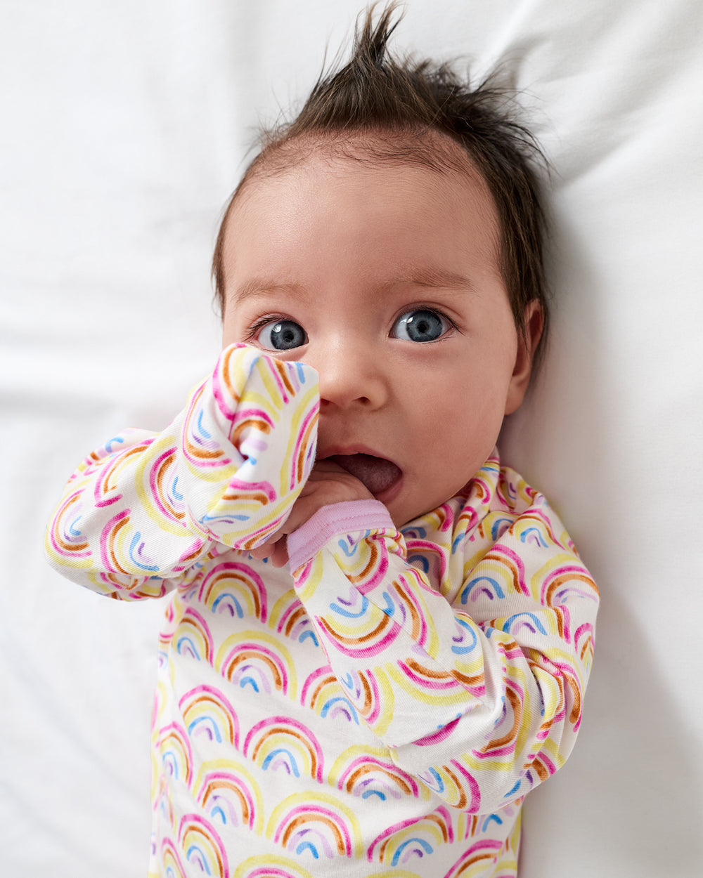 Close up of newborn wearing the Pastel Rainbows Infant Gown