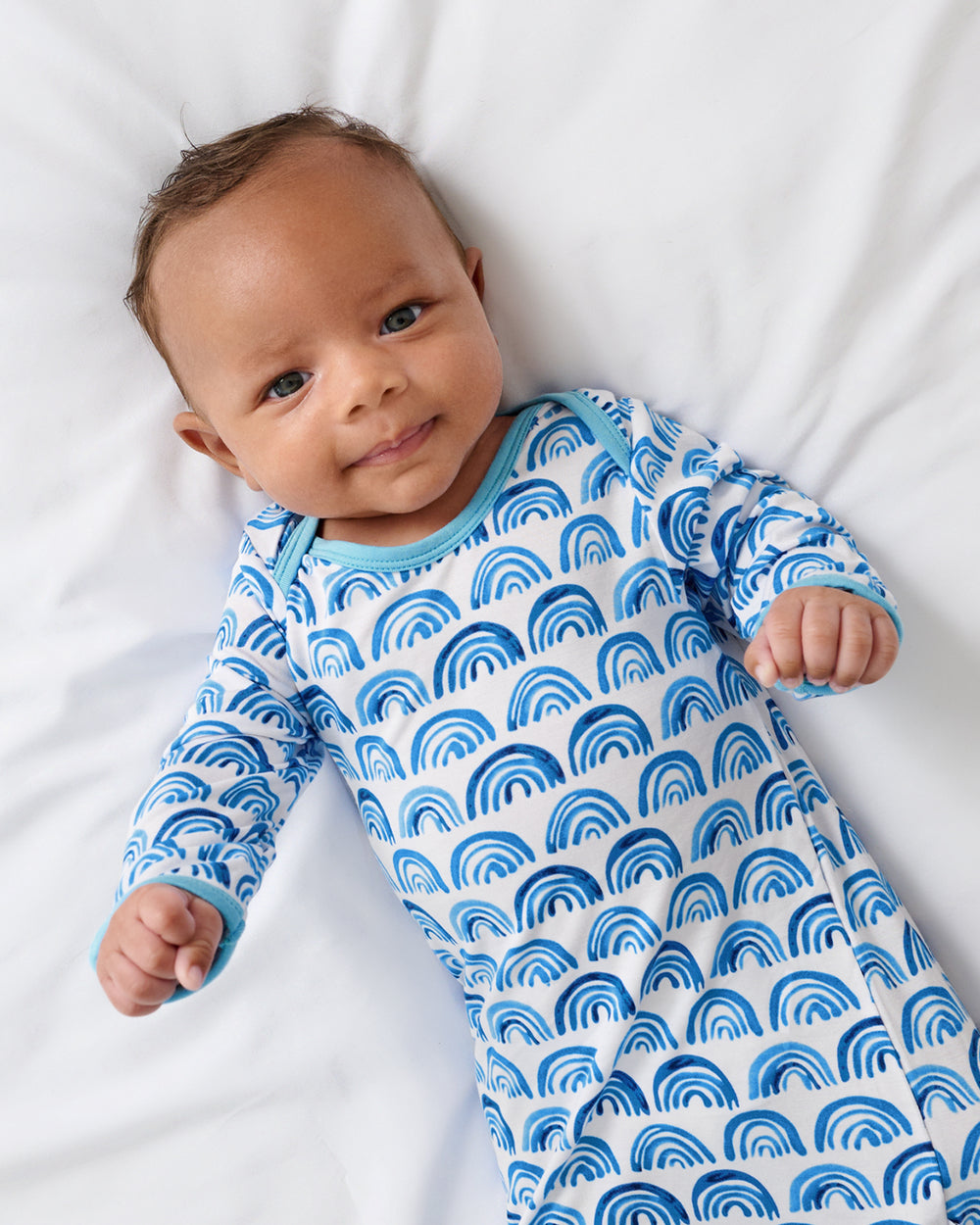 Close up of newborn boy wearing the Blue Rainbows Infant Gown