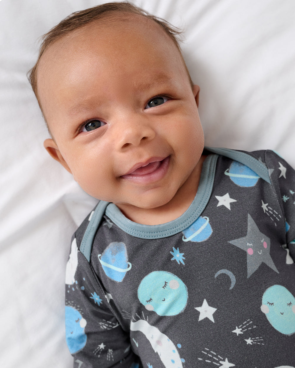 Close up of newborn boy wearing the Blue To the Moon & Back Infant Gown