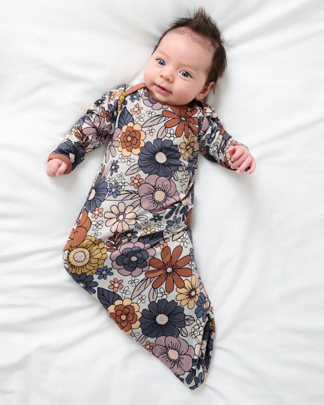 Aerial view of baby wearing the Wildwood Floral Infant Gown