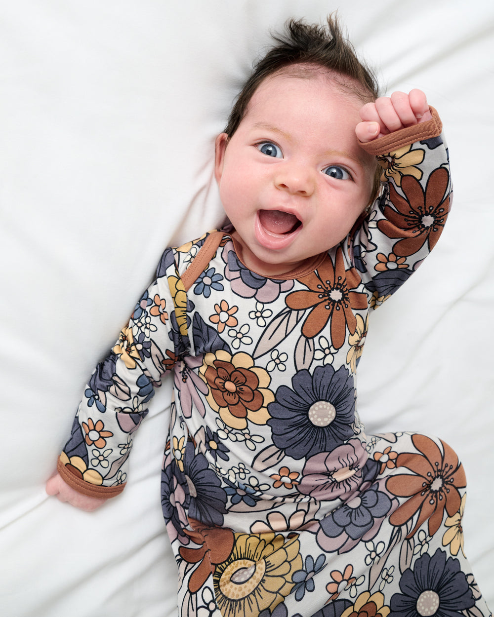 Close up of baby wearing the Wildwood Floral Infant Gown