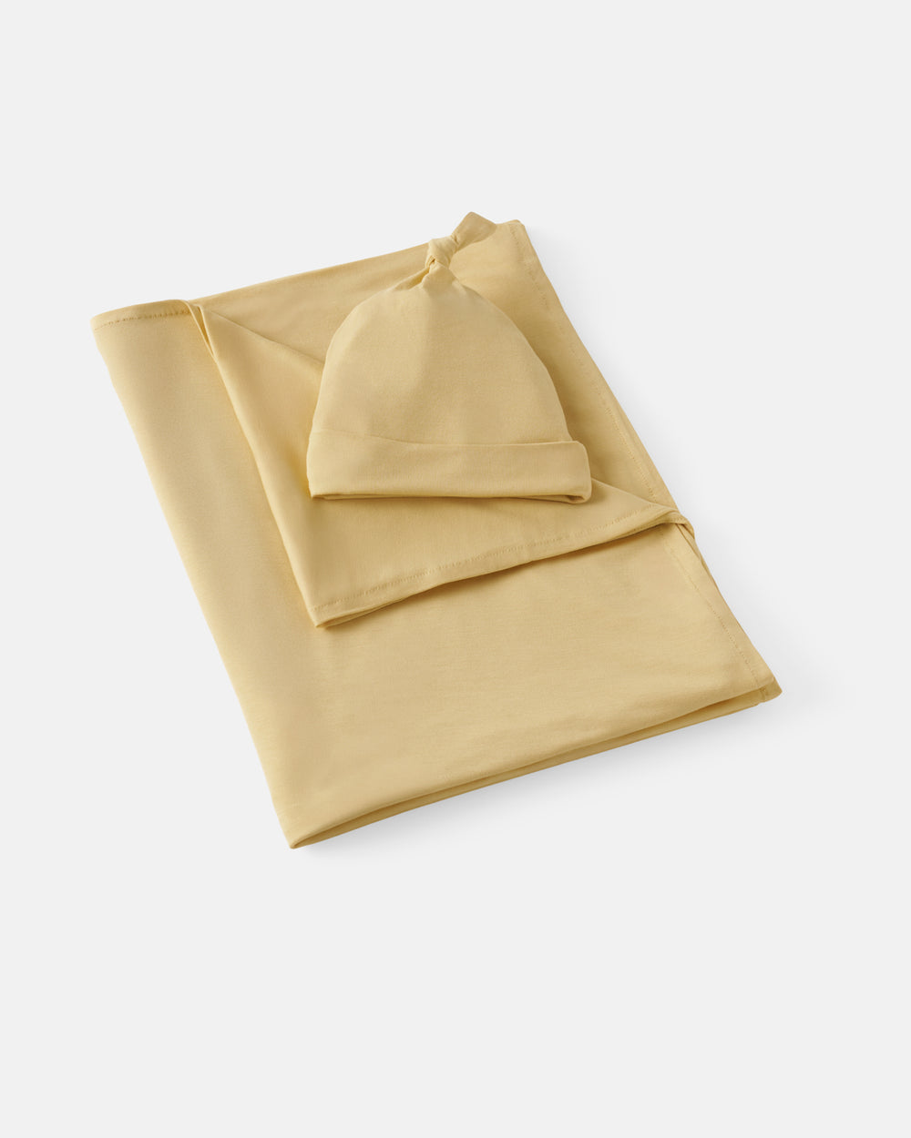 Flat lay of the Sunglow Swaddle & Hat Set