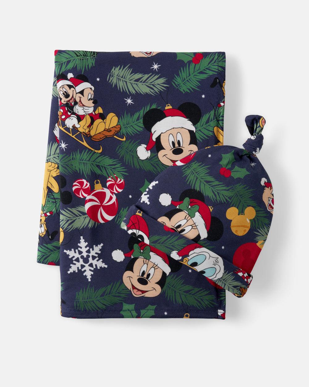 A Disney Mickey Mouse Christmas-themed fabric set including a towel, a washcloth, and a small knotted bag, featuring a navy blue background with green pine branches, red Santa hats, candy canes, and Mickey Mouse illustrations.