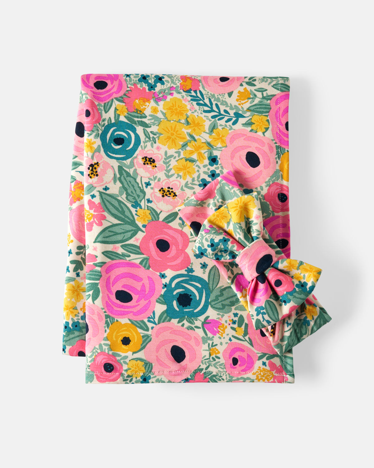 Flat lay of the Secret Garden Swaddle & Luxe Bow Headband Set