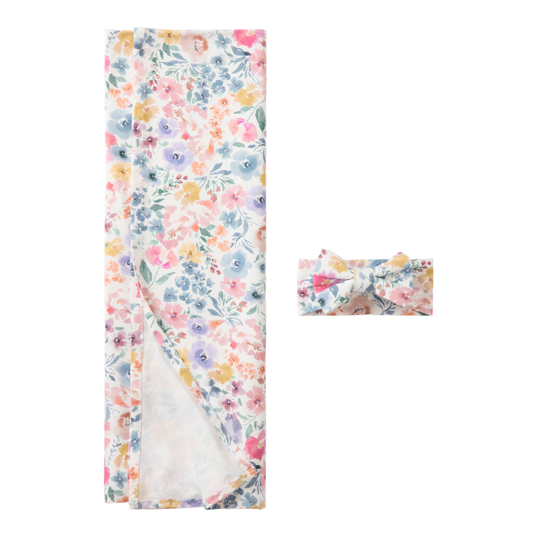 Floral-patterned baby blanket and headband on a white background