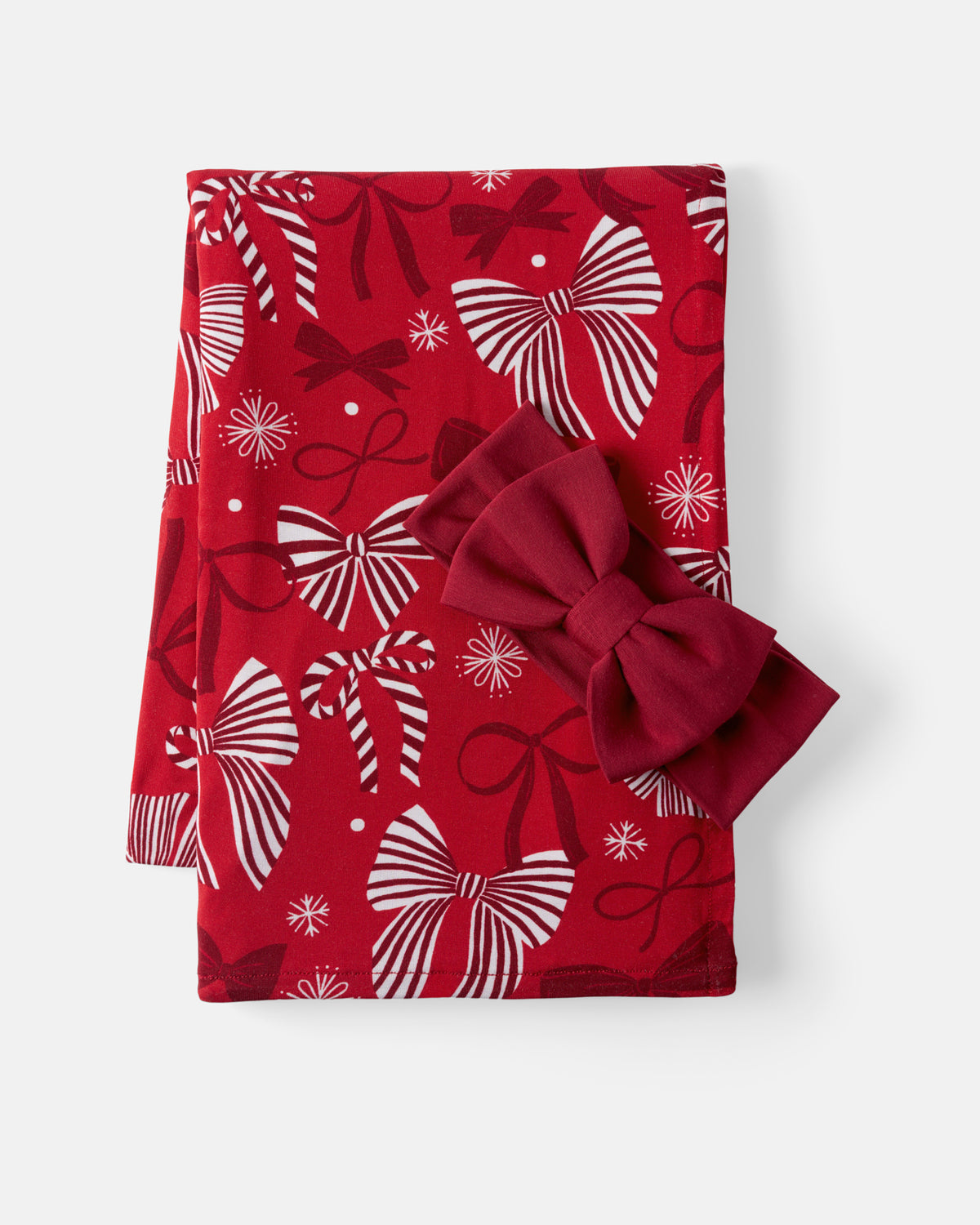 Flat lay of the Holiday Bows Swaddle & Luxe Bow Headband Set