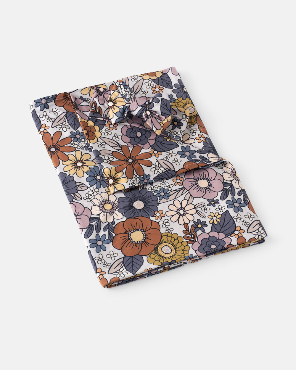 Flat lay of the Wildwood Floral Swaddle & Luxe Bow Headband Set