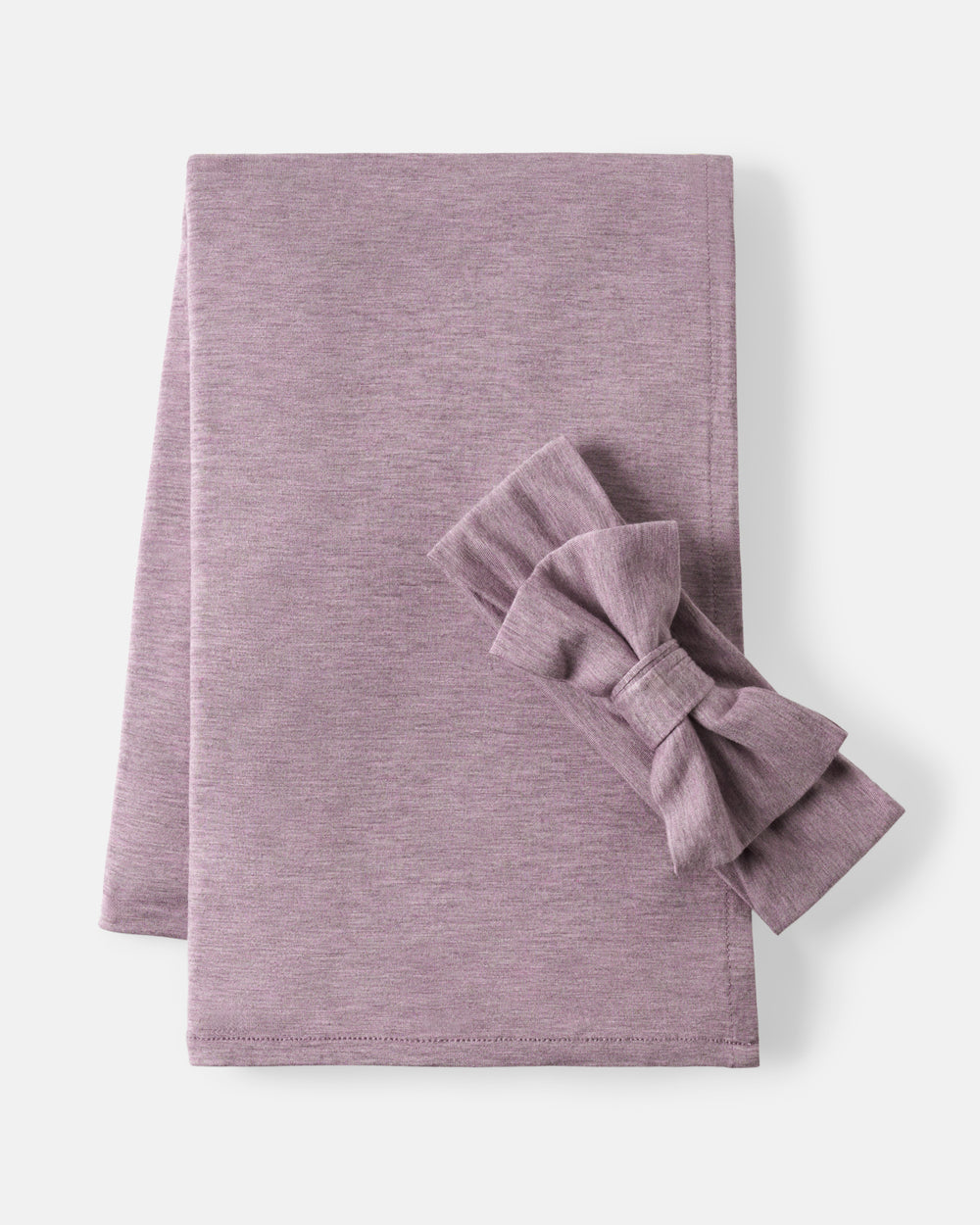A folded dusty purple fabric napkin with a matching fabric bow, displayed on a clean off-white background.