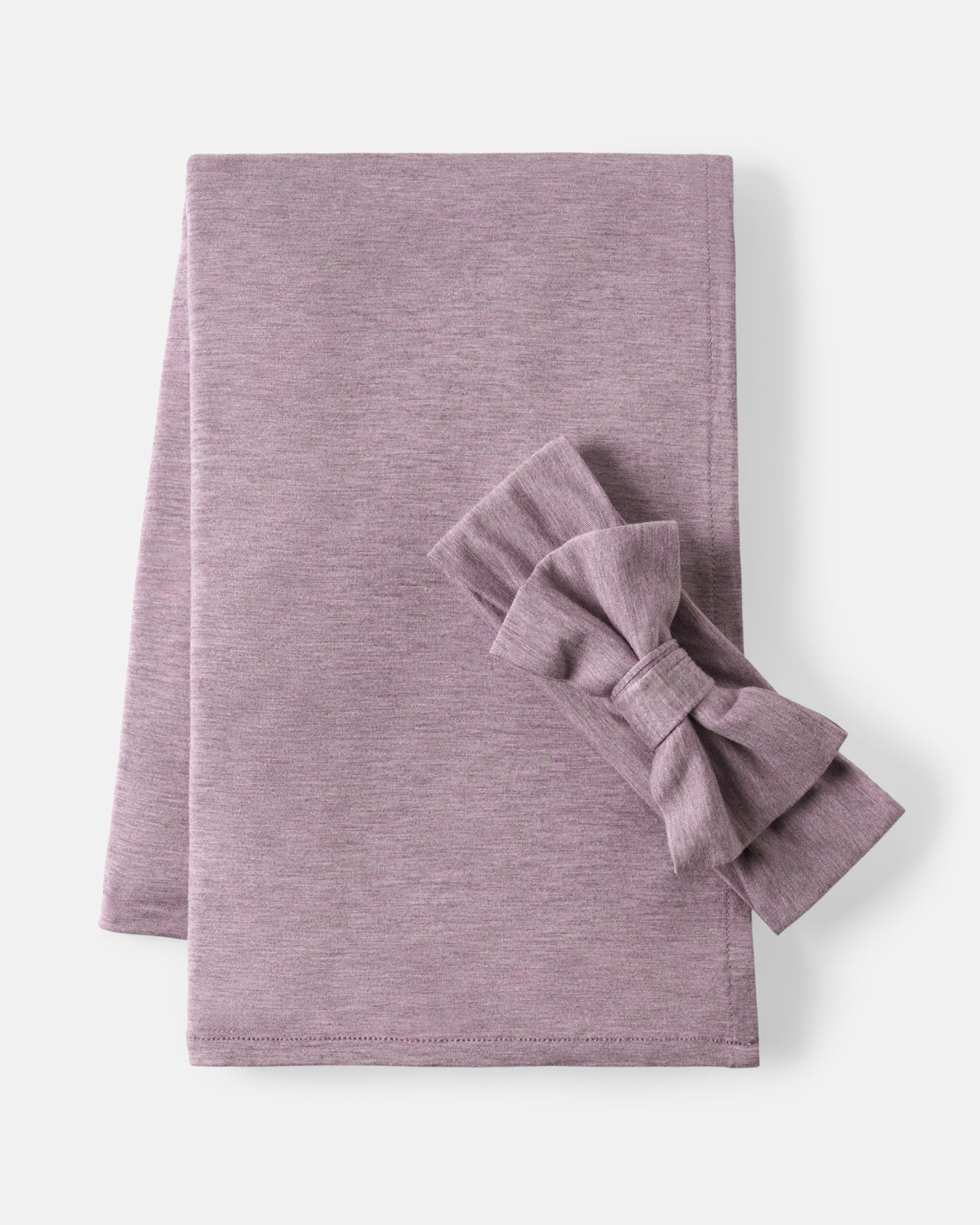 A folded dusty purple fabric napkin with a matching fabric bow, displayed on a clean off-white background.