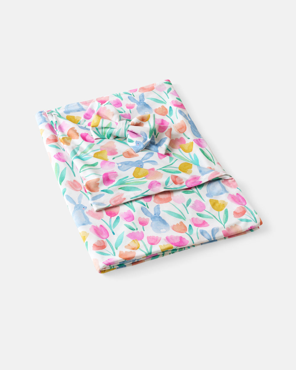 Flat lay of the Garden Hop Swaddle & Luxe Bow Headband Set
