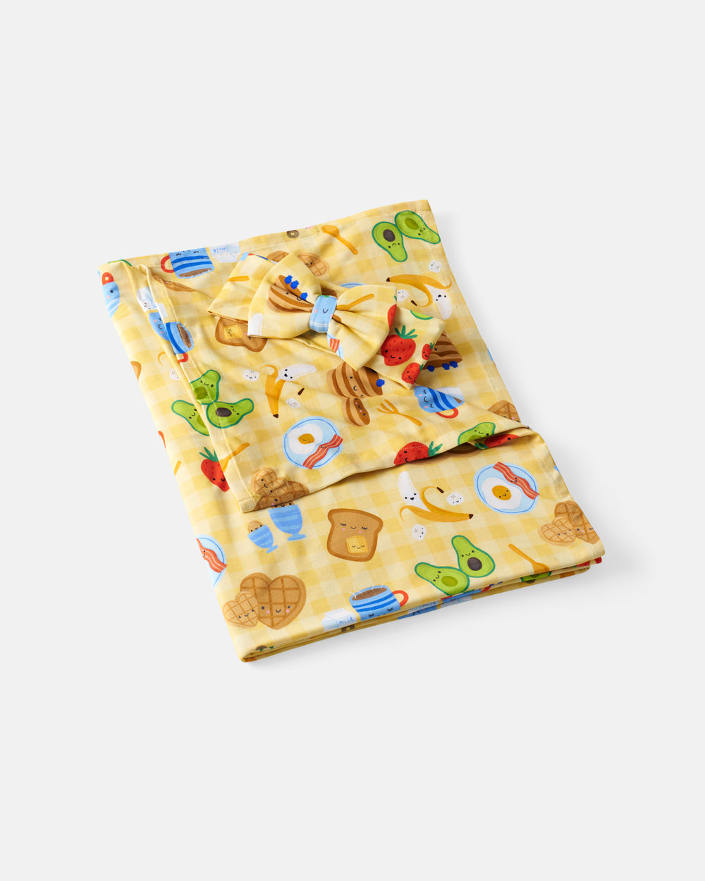 Flat lay of the Breakfast Bunch Swaddle & Luxe Bow Headband Set