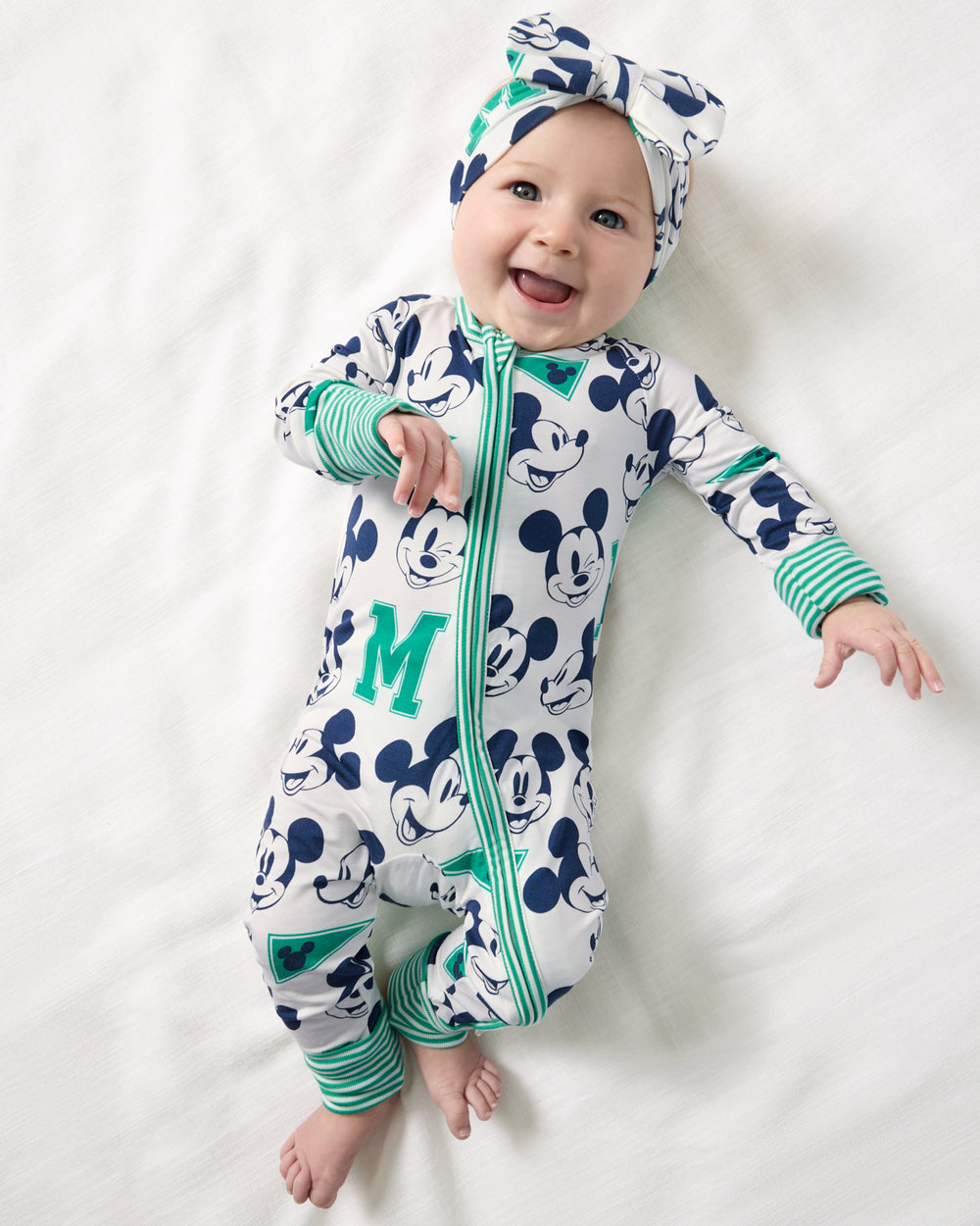 Aerial view of newborn wearing the Disney Varsity Mickey Mouse Zippy and Luxe Bow