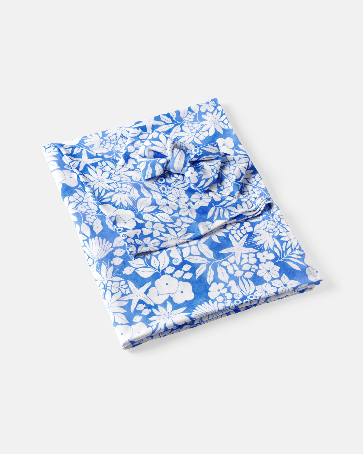 Flat lay of the Azure Garden Swaddle & Luxe Bow Headband Set