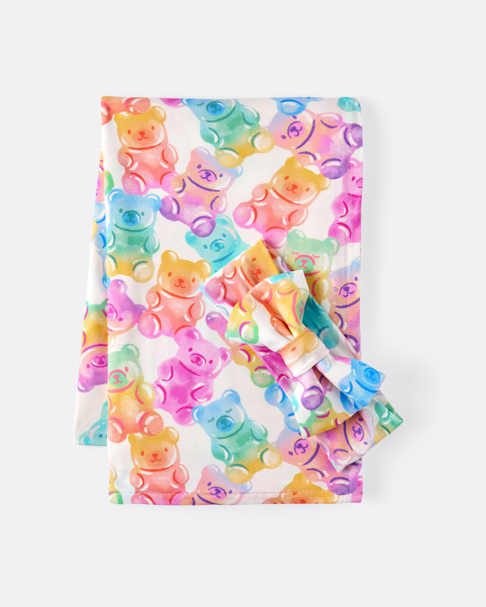 Flat lay of the Gummy Giggles Swaddle & Luxe Bow Headband Set