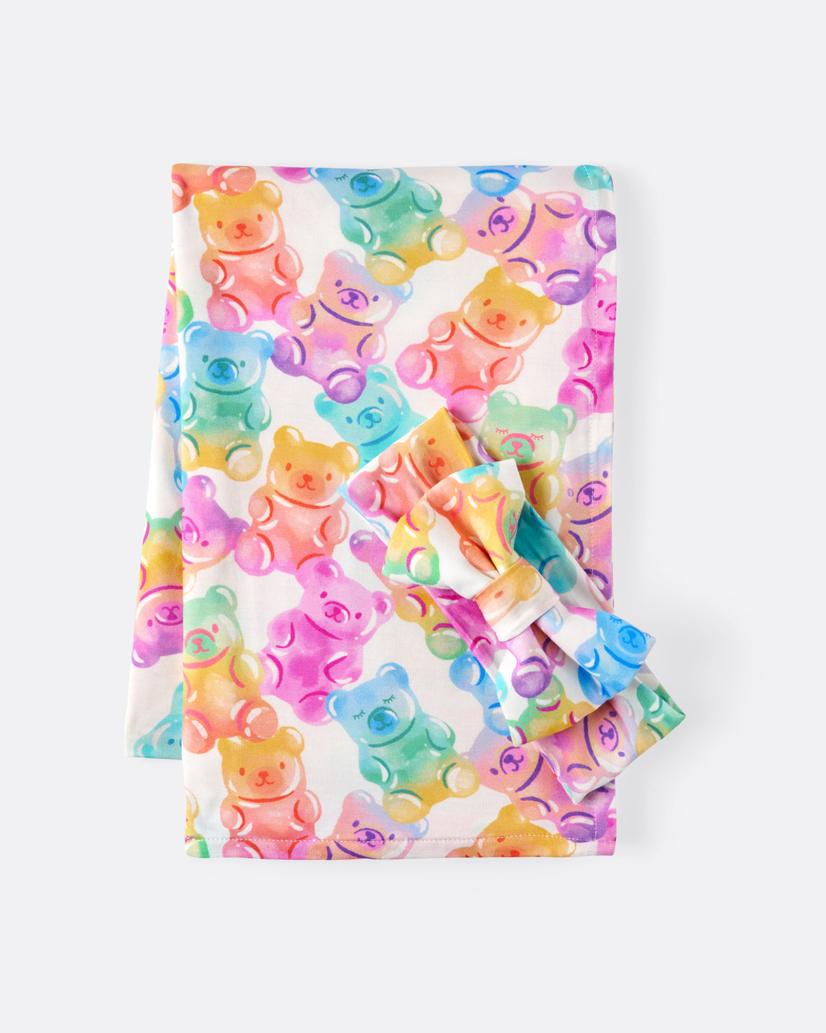 Flat lay of the Gummy Giggles Swaddle & Luxe Bow Headband Set