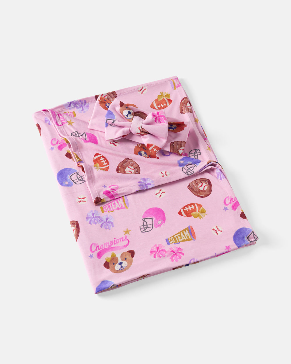 Flat lay of the Team Spirit Pink Swaddle & Luxe Bow Headband Set