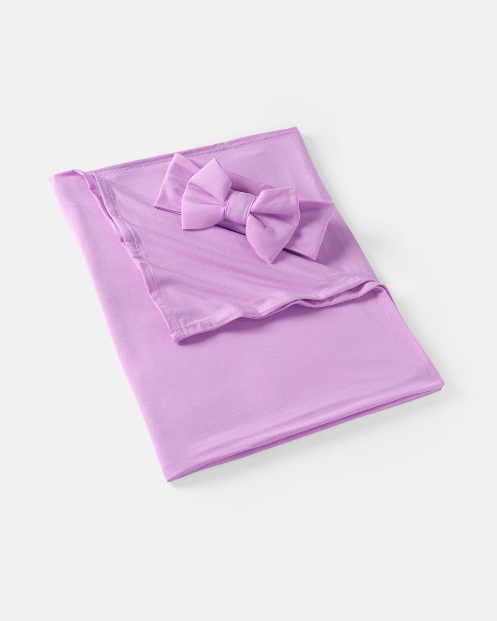 Flat lay of the Soft Wisteria Swaddle & Luxe Bow Headband Set