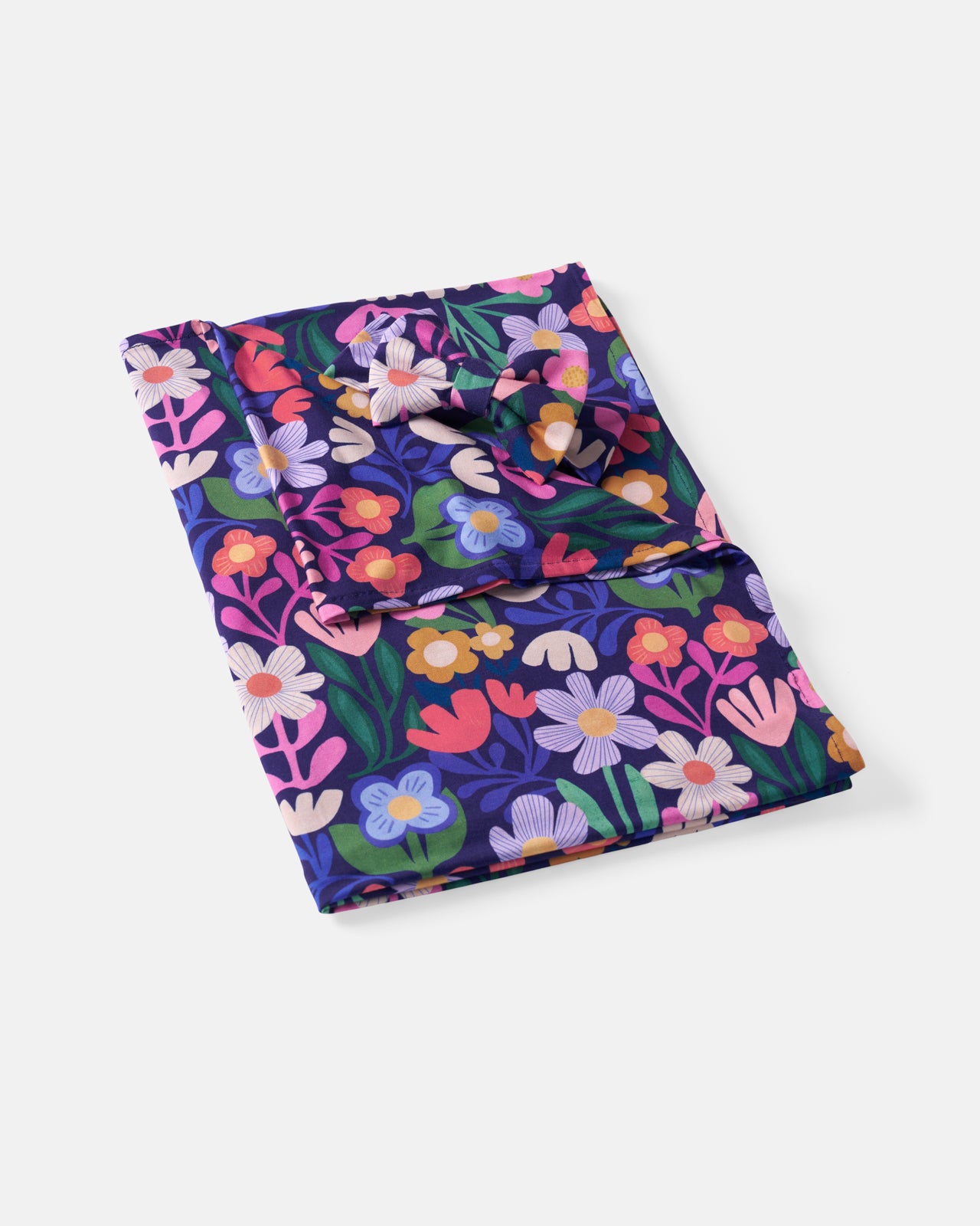 Flat lay of the Wild Garden Swaddle & Luxe Bow Headband Set