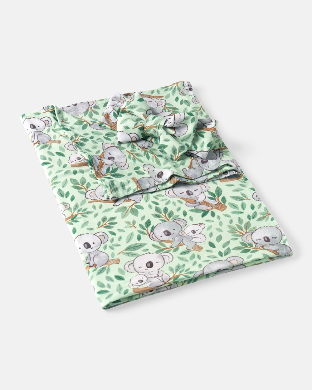 Flat lay of the Koala Cuddles Swaddle & Luxe Bow Headband Set