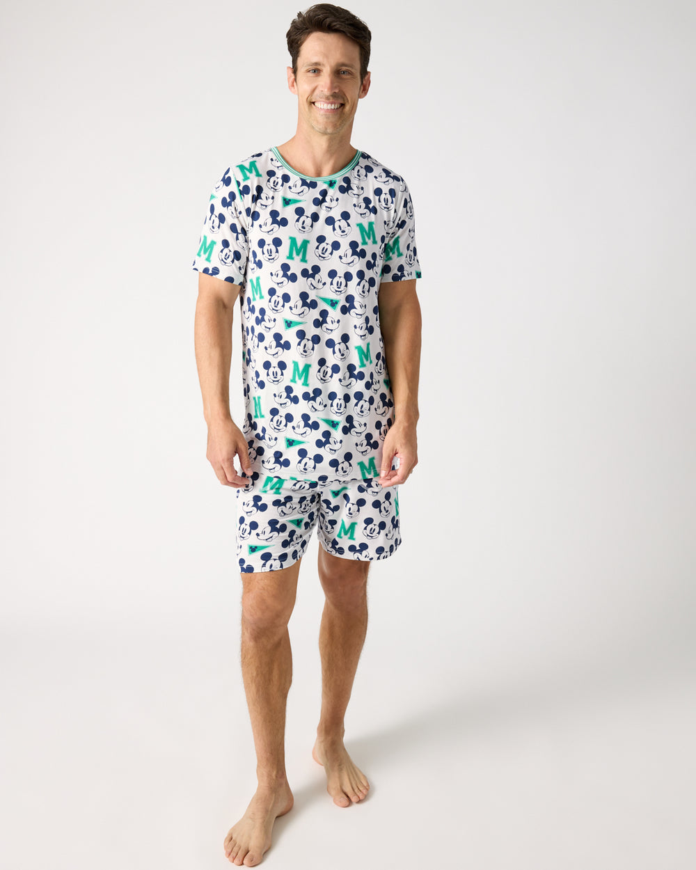 Man wearing the Disney Varsity Mickey Mouse Men's Short Sleeve Pajama Top and Shorts