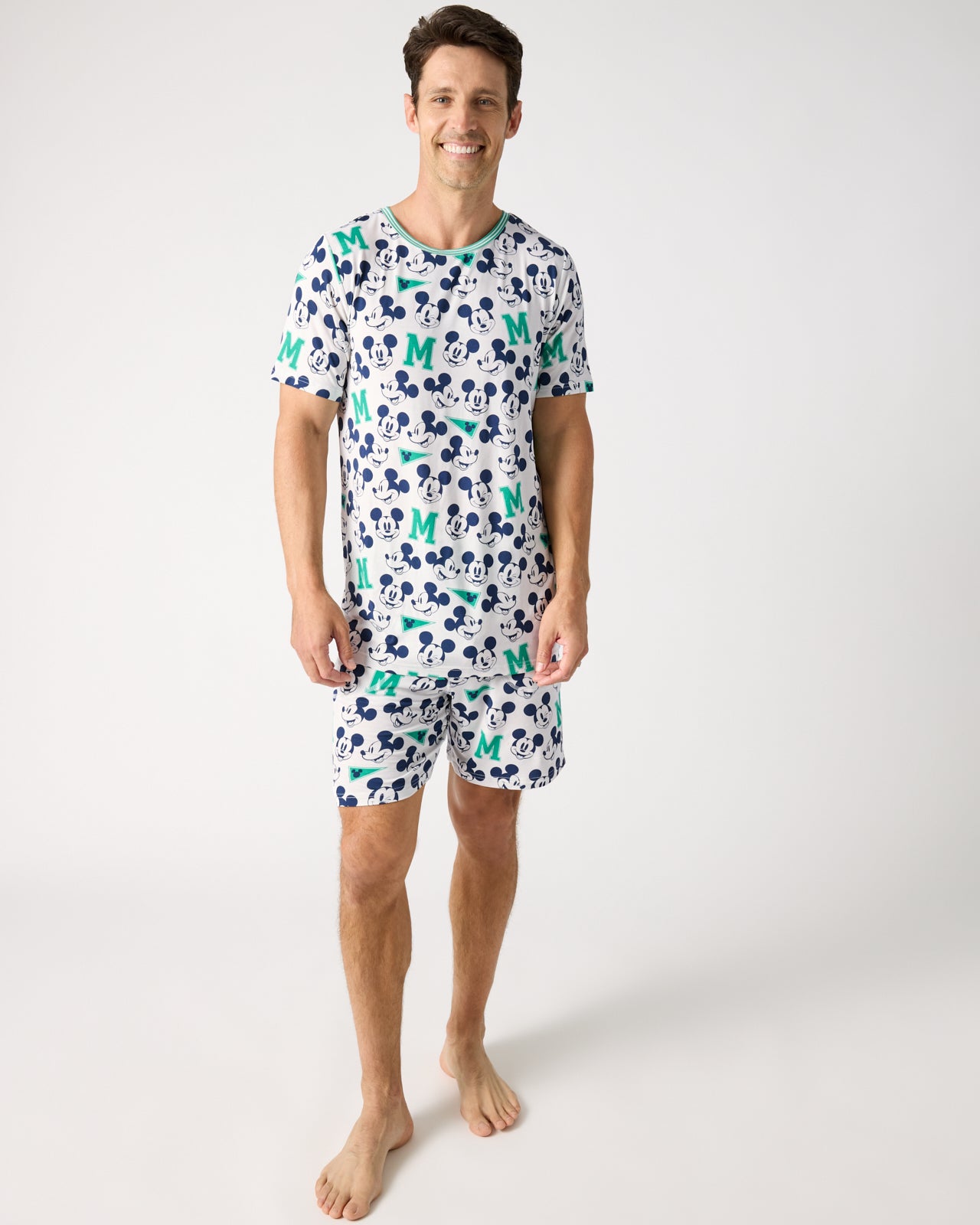 Man wearing the Disney Varsity Mickey Mouse Men's Short Sleeve Pajama Top and Shorts