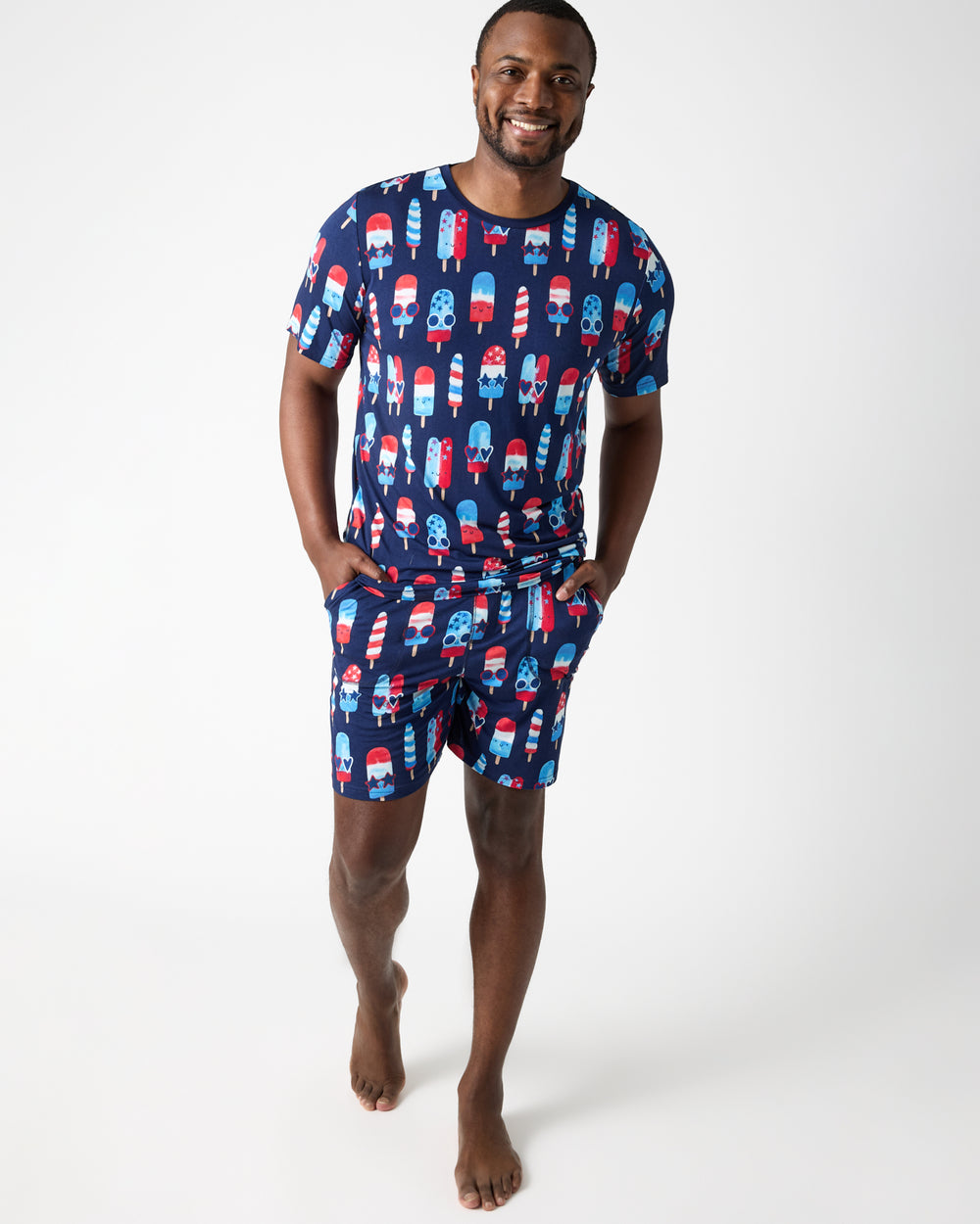 Man wearing the Sparkle Treats Men's Short Sleeve Pajama Top and Shorts