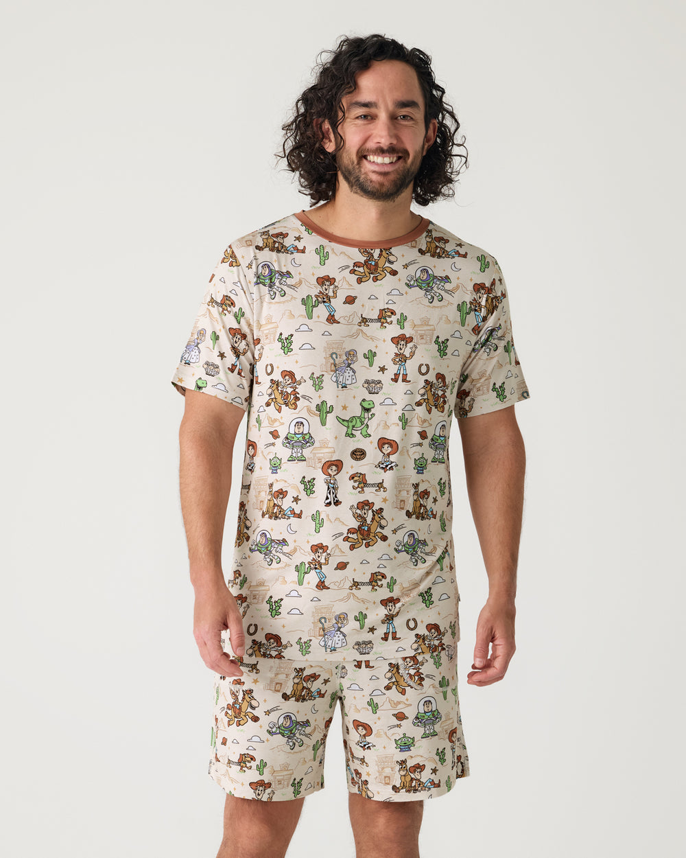 Man wearing the Disney & Pixar Woody's Wild West Men's Short Sleeve Pajama Top