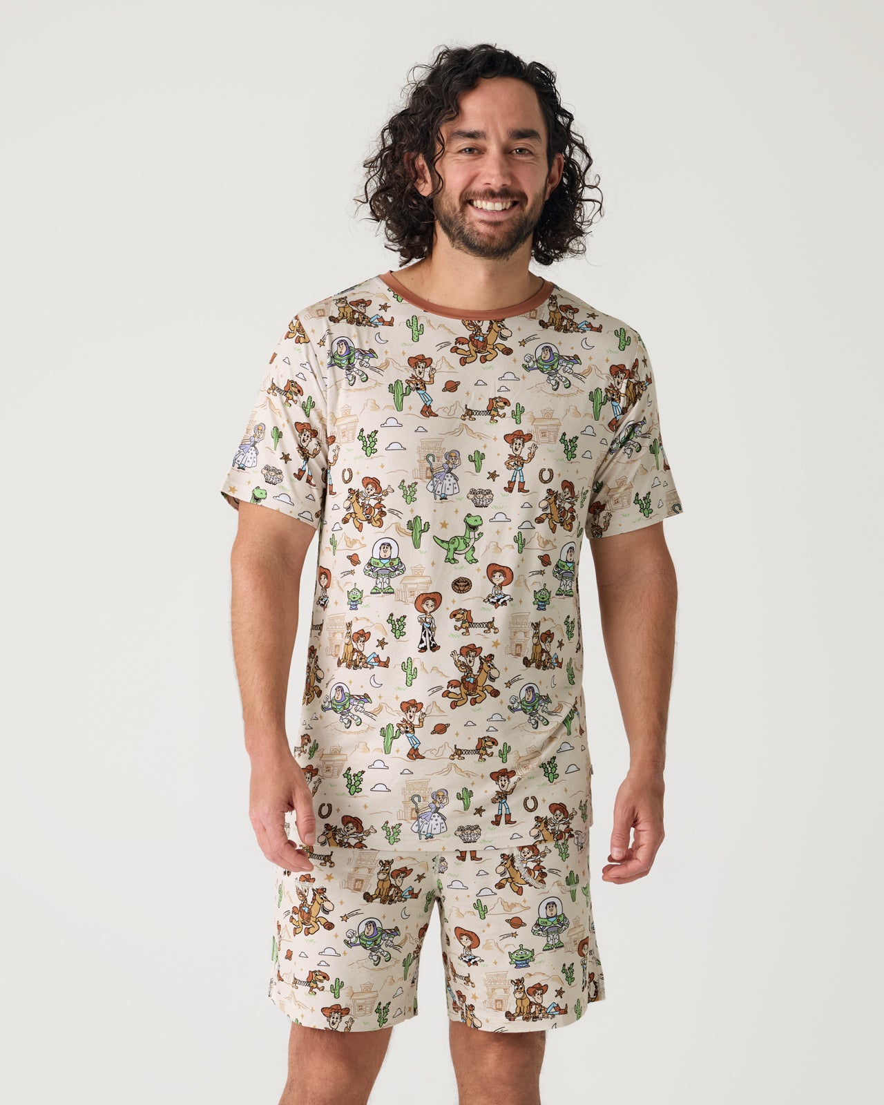 Man wearing the Disney & Pixar Woody's Wild West Men's Short Sleeve Pajama Top