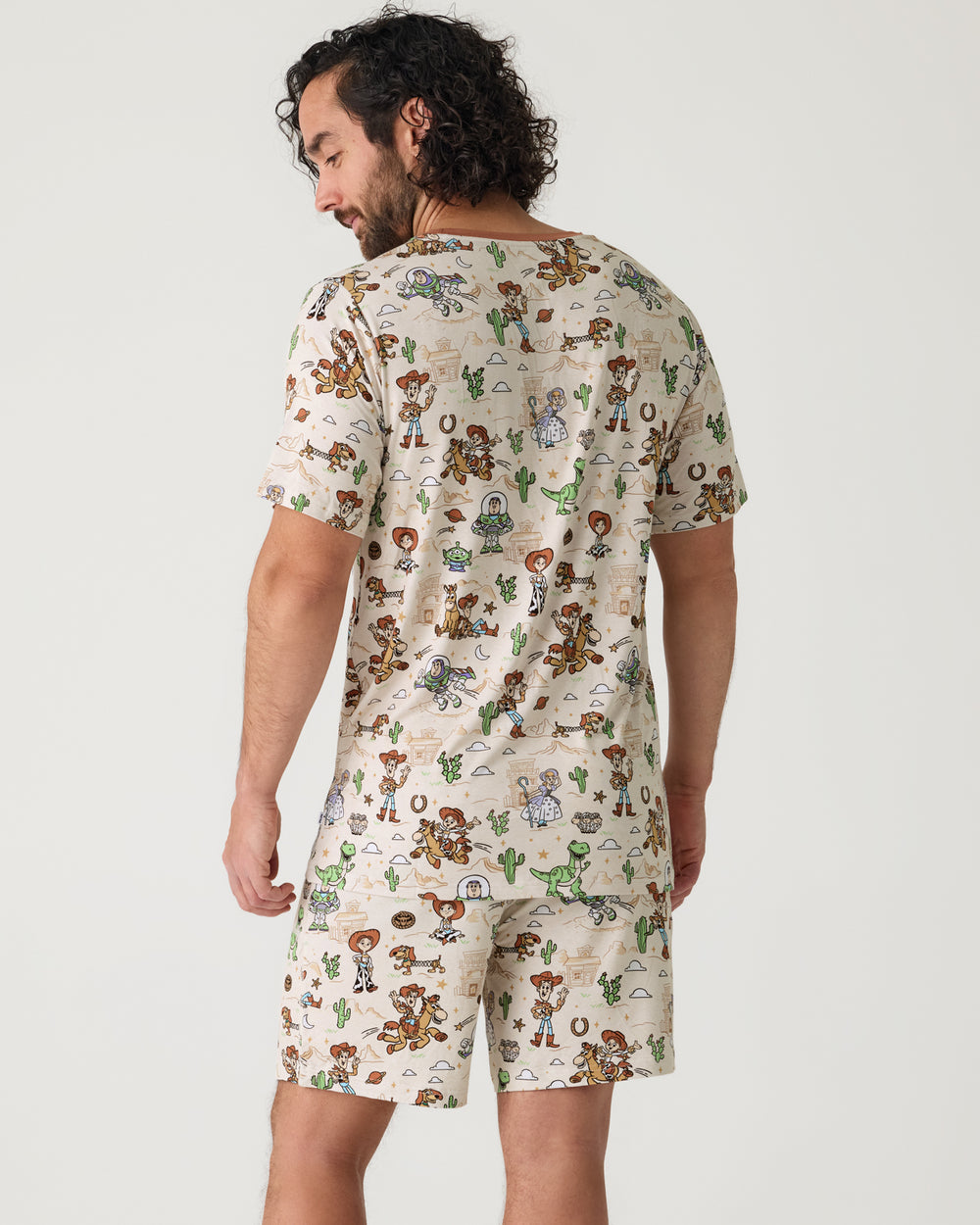 Back view of man wearing the Disney & Pixar Woody's Wild West Men's Short Sleeve Pajama Top