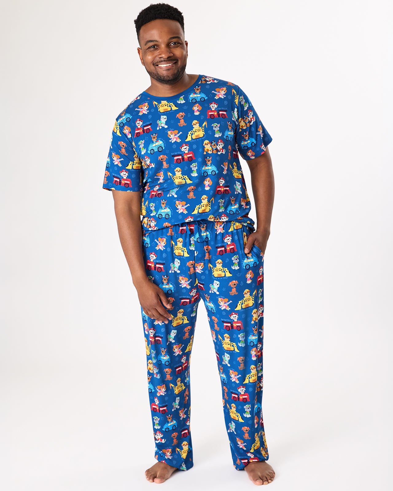 Man wearing the PAW Patrol Adventure Bay Heroes Men's Short Sleeve Pajama Top and Pants