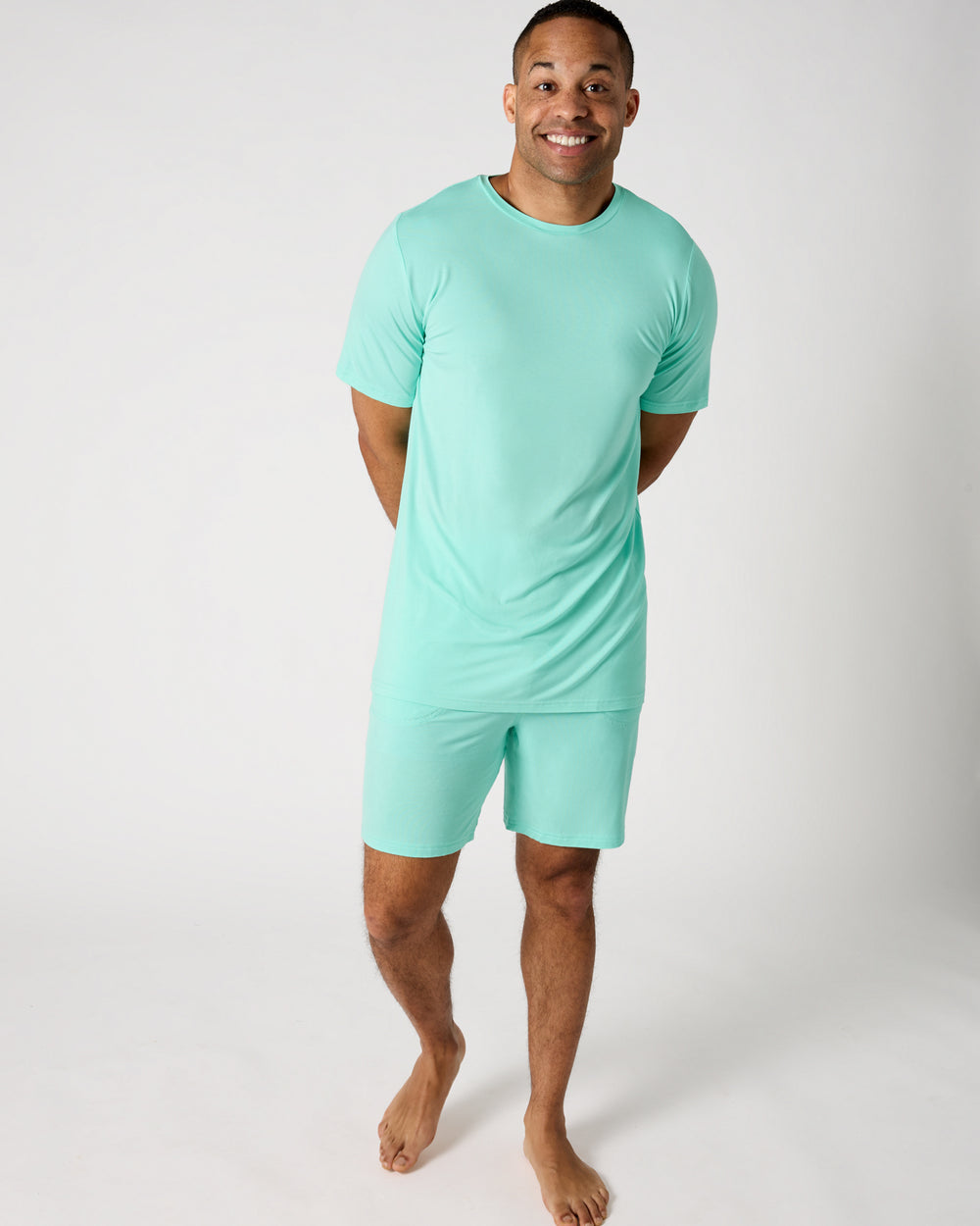 Man wearing the Ocean Mist Men's Short Sleeve Pajama Top and Shorts