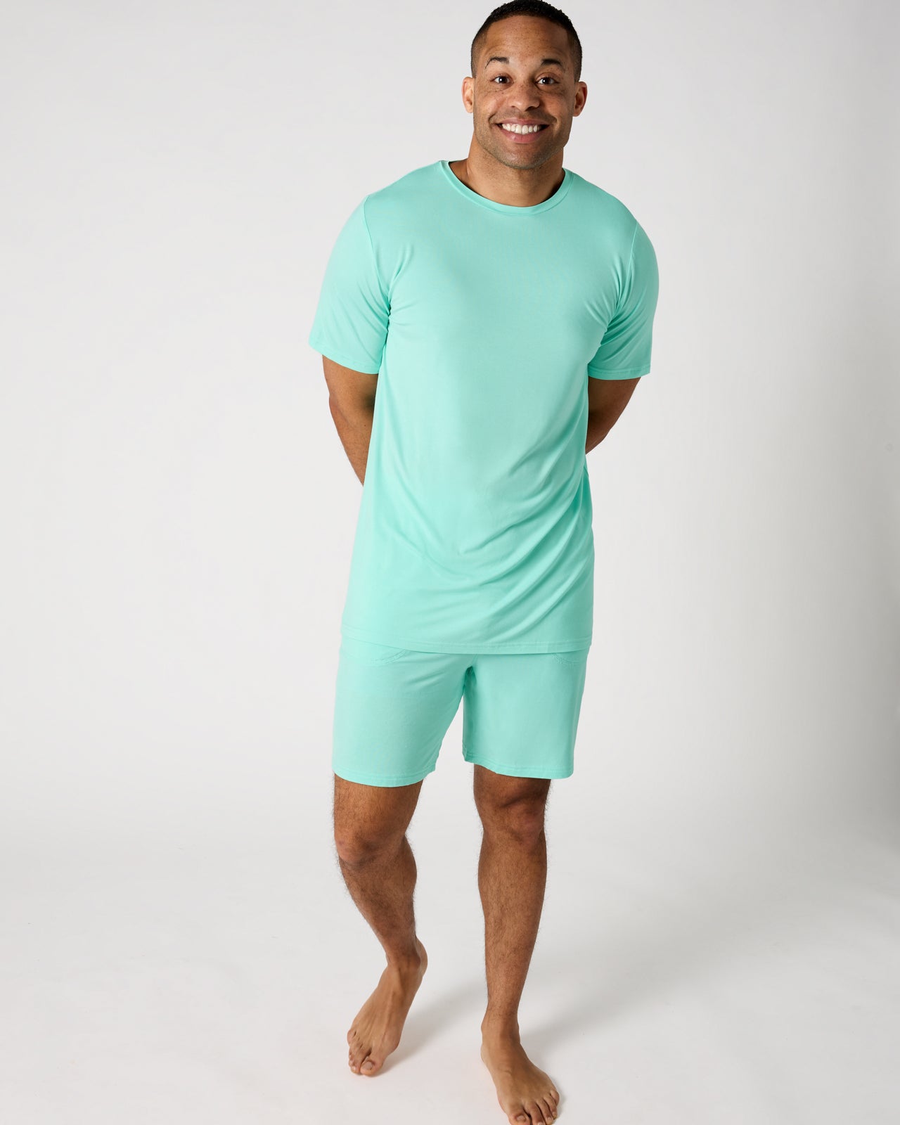 Man wearing the Ocean Mist Men's Short Sleeve Pajama Top and Shorts