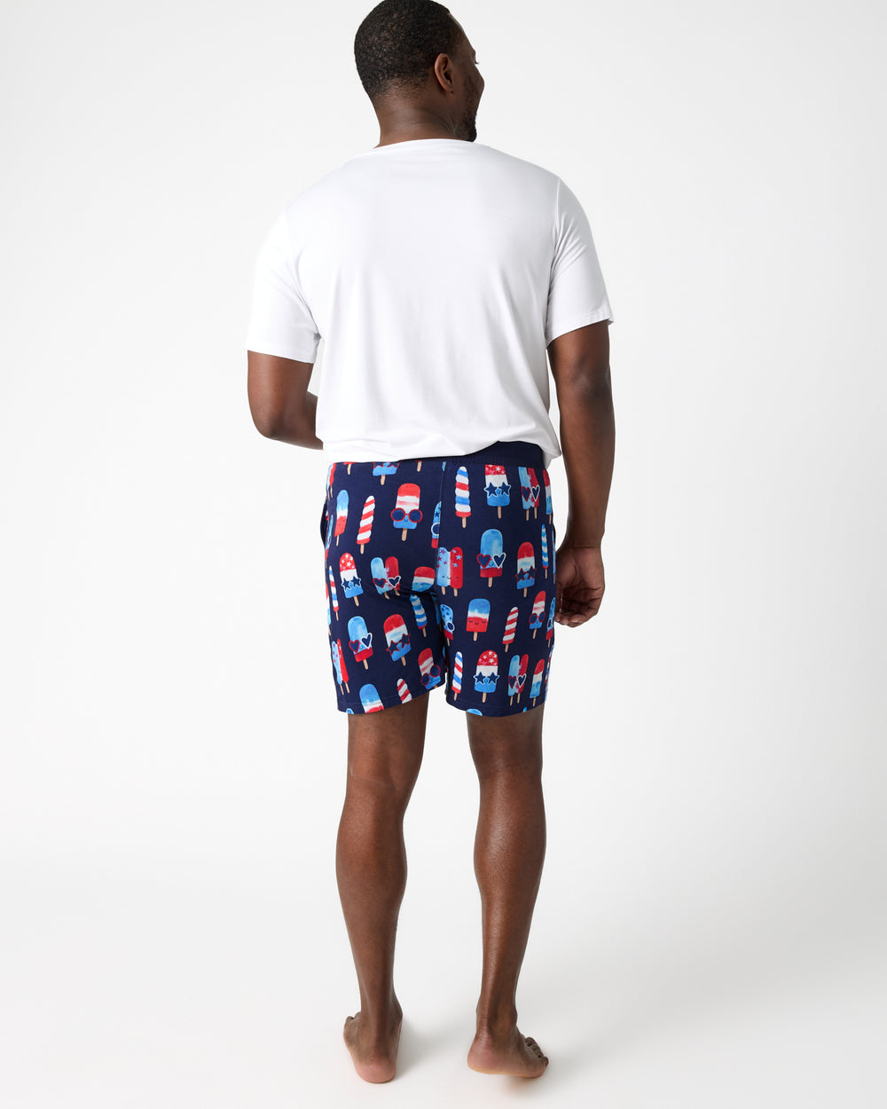 Back view of man wearing the Sparkle Treats Men's Pajama Shorts and white pajama top