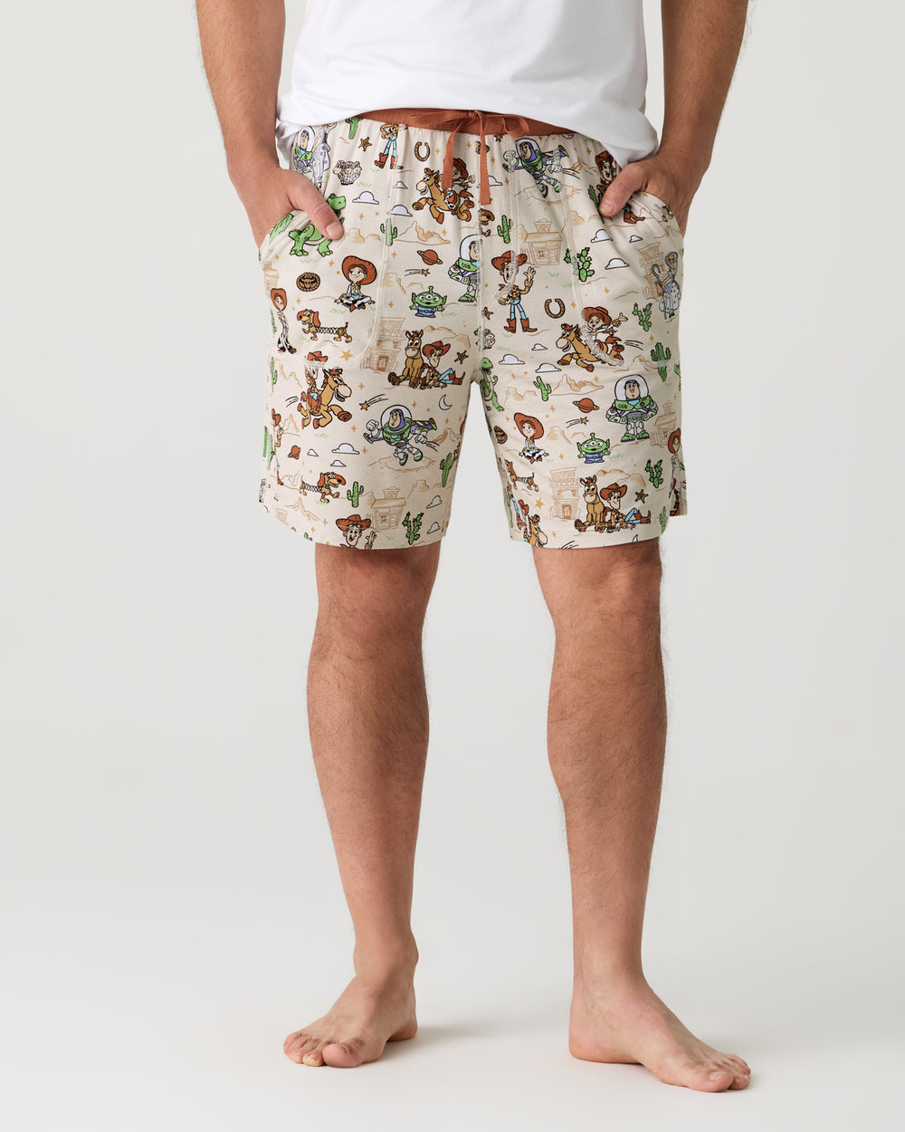 Man wearing the Disney & Pixar Woody's Wild West Men's Pajama Shorts