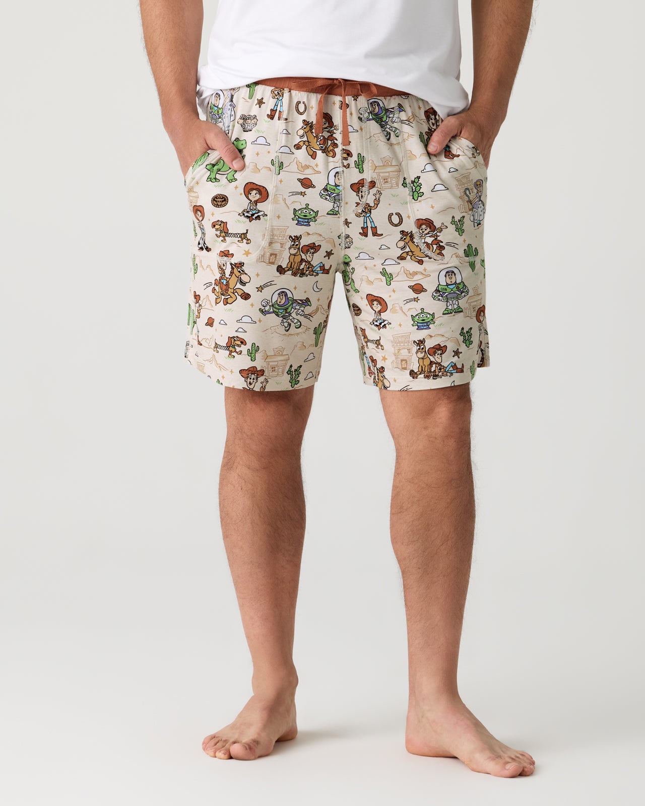 Man wearing the Disney & Pixar Woody's Wild West Men's Pajama Shorts