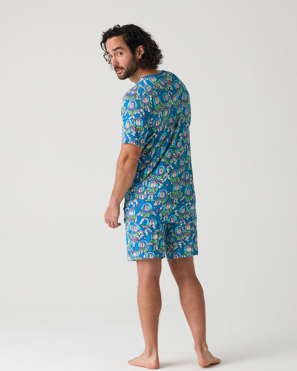 Back view of man wearing the Disney & Pixar Buzz's Cosmic Crew Men's Short Sleeve Pajama Top and Shorts