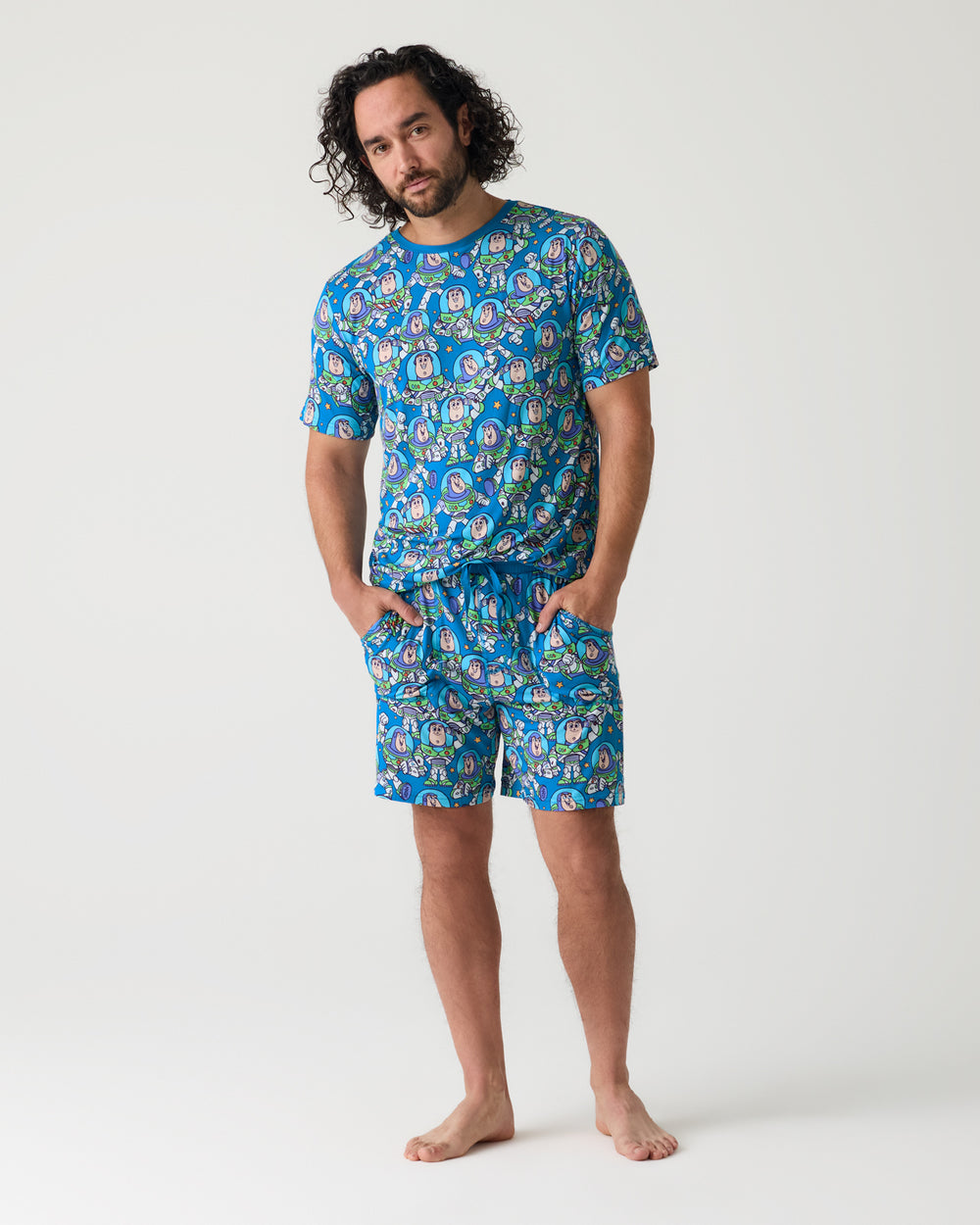 Man wearing the Disney & Pixar Buzz's Cosmic Crew Men's Short Sleeve Pajama Top and Shorts